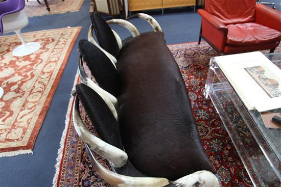 Anthony Redmile. An unusual cow horn and hide three seat settee, W.5ft 8in.